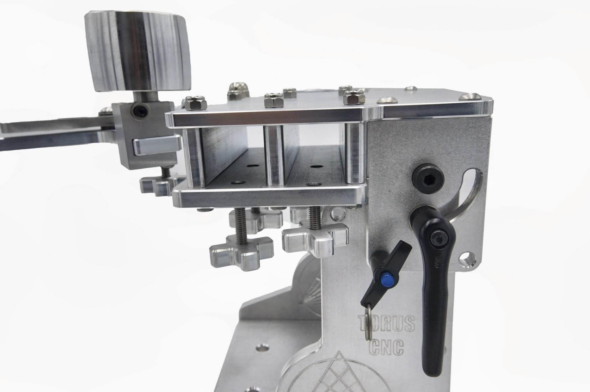 Cross-knob tension adjusters and idler wheel mount on a Torus CNC 2x72 grinder tooling arm