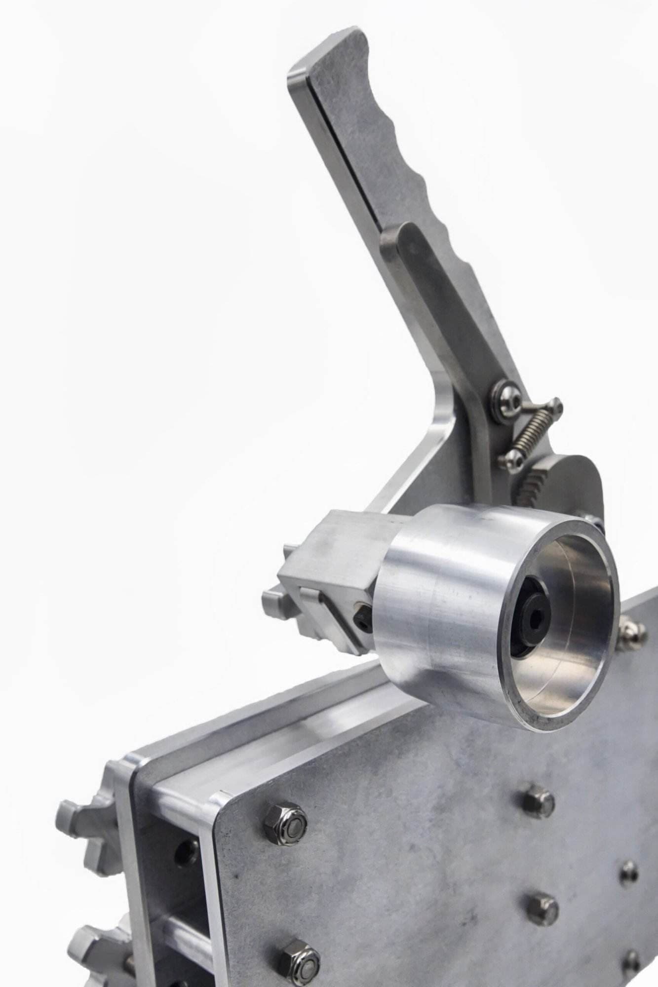Idler wheel cup with square mounting block bolted to a Torus CNC grinder tooling arm plate