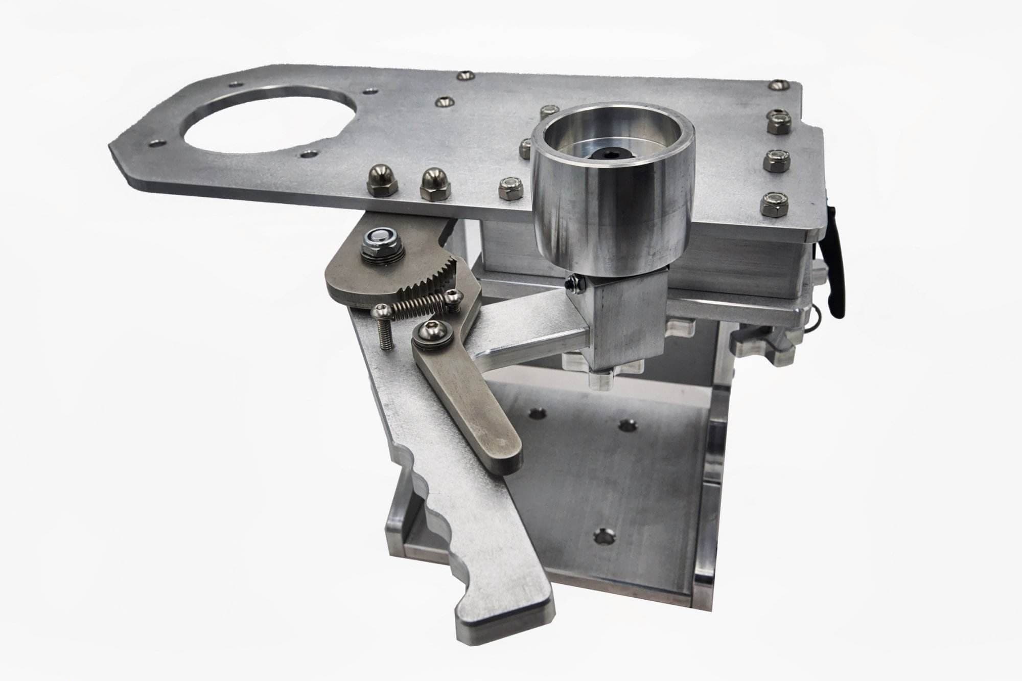 Large circular mounting plate cutout with ratchet cam lever on a Torus CNC grinder tooling arm