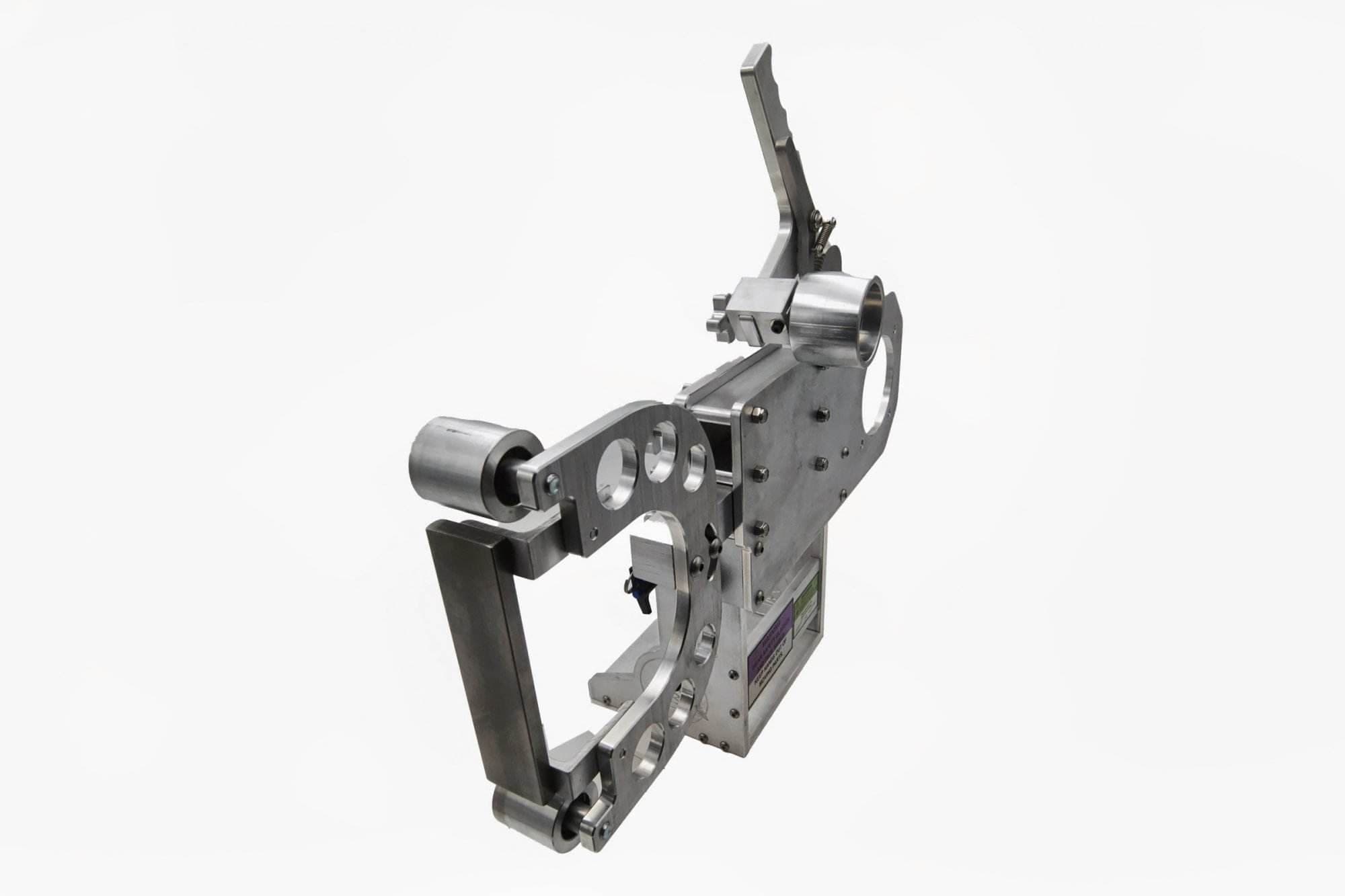 Torus CNC grinder tooling arm with contact wheel and safety warning labels on the base
