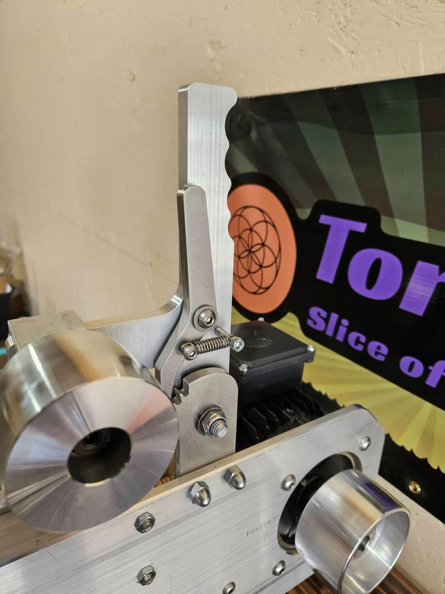 Close-up of the drive wheel and motor mount on a Torus CNC belt grinder chassis