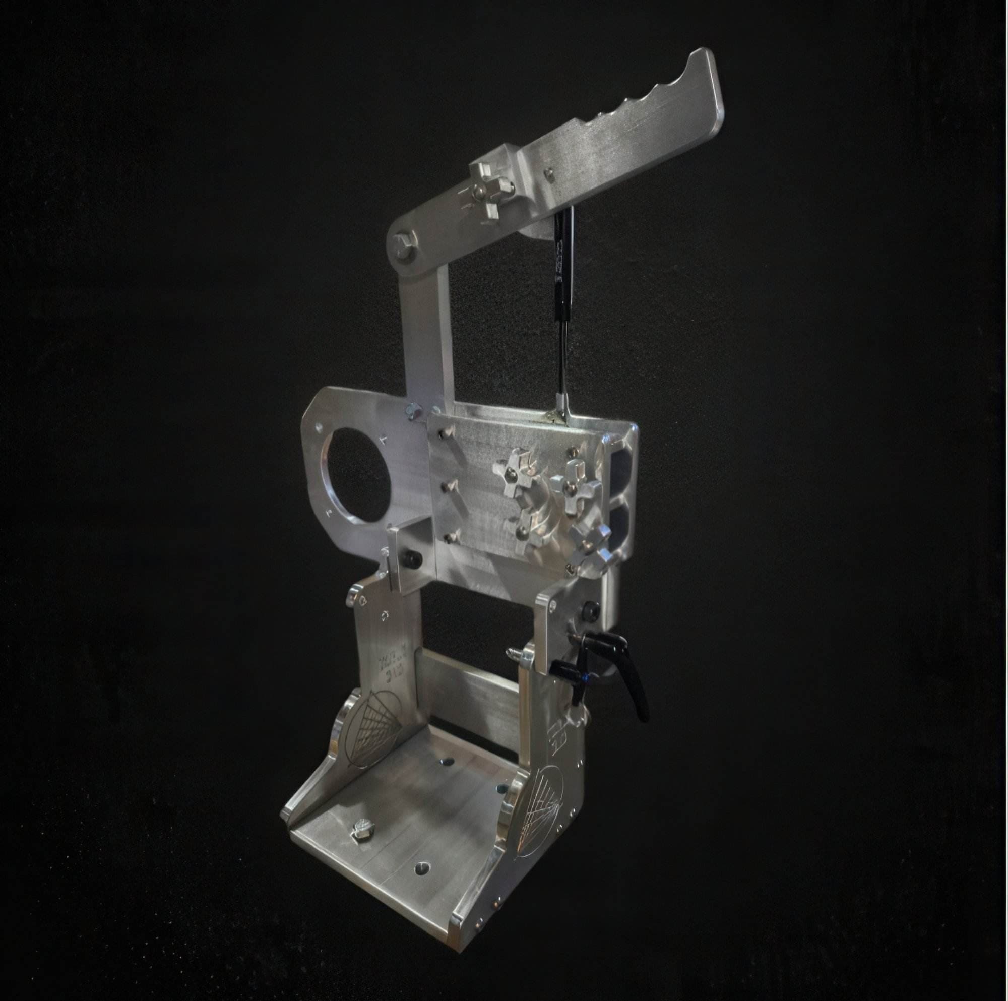 Aluminum grinder chassis assembly with adjustable tracking arm on a black background