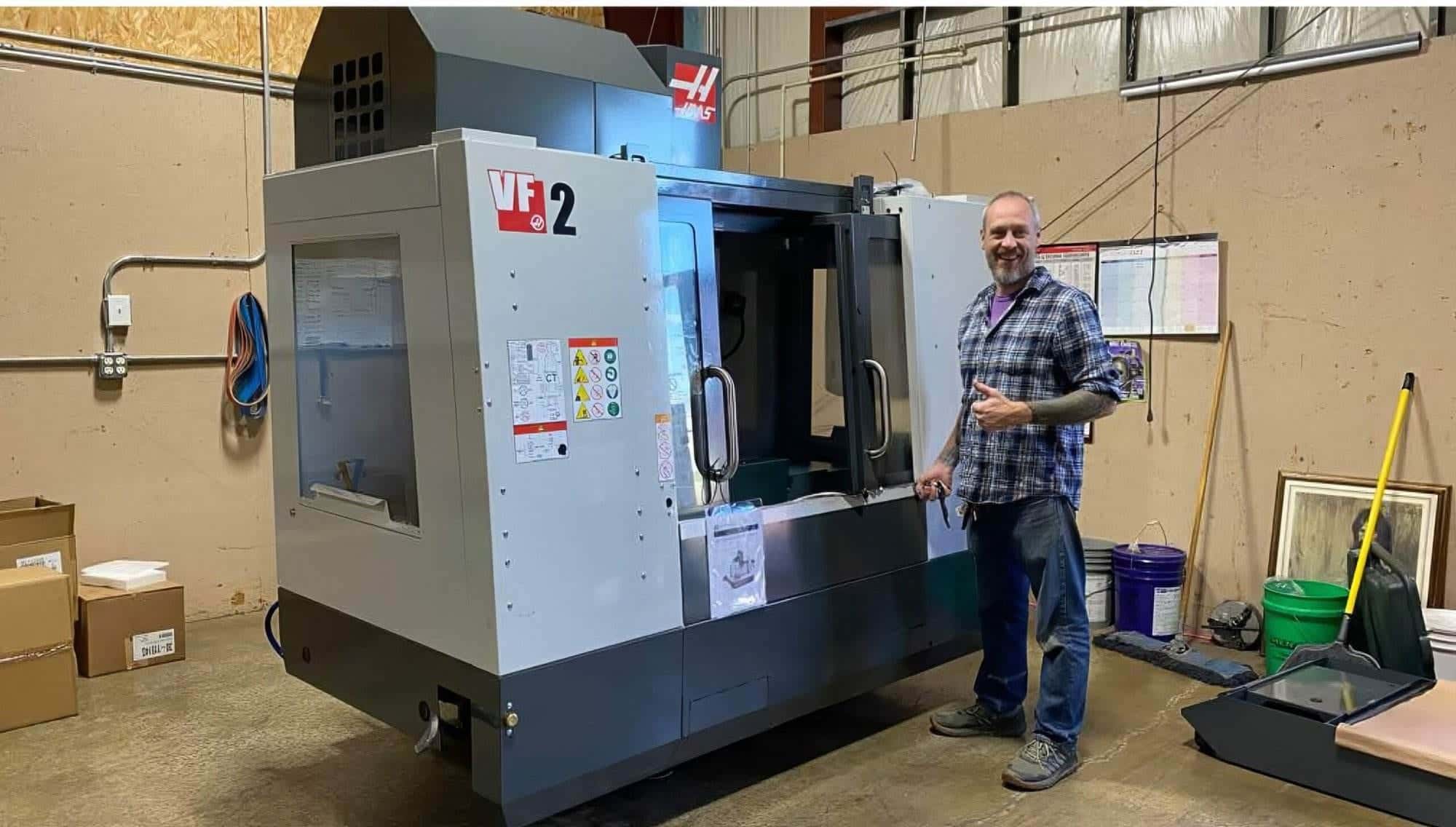 Rich Linville beside the HAAS VF-2 in the Torus CNC shop