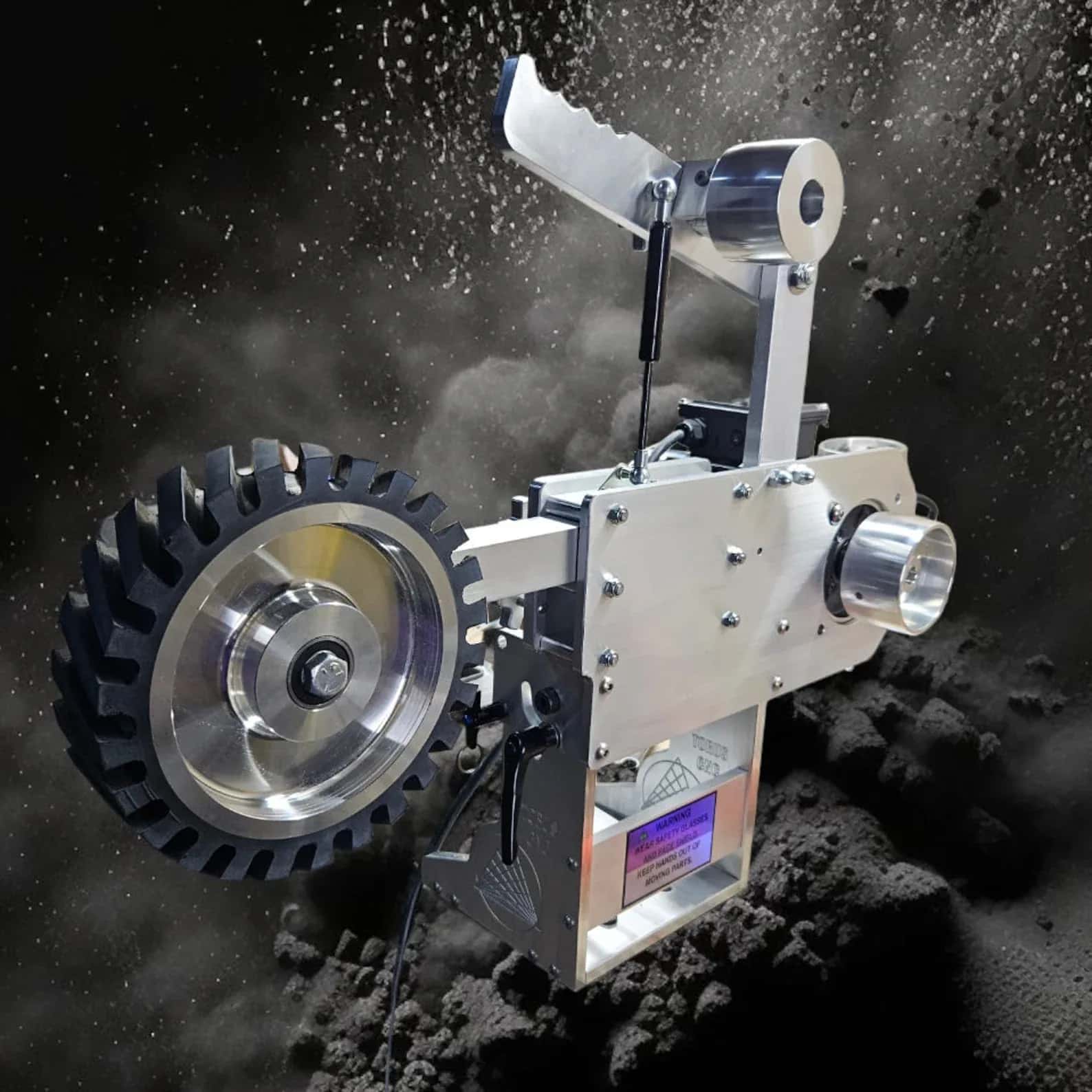 Torus CNC 2x72 belt grinder head with contact wheel against a dust and sparks backdrop