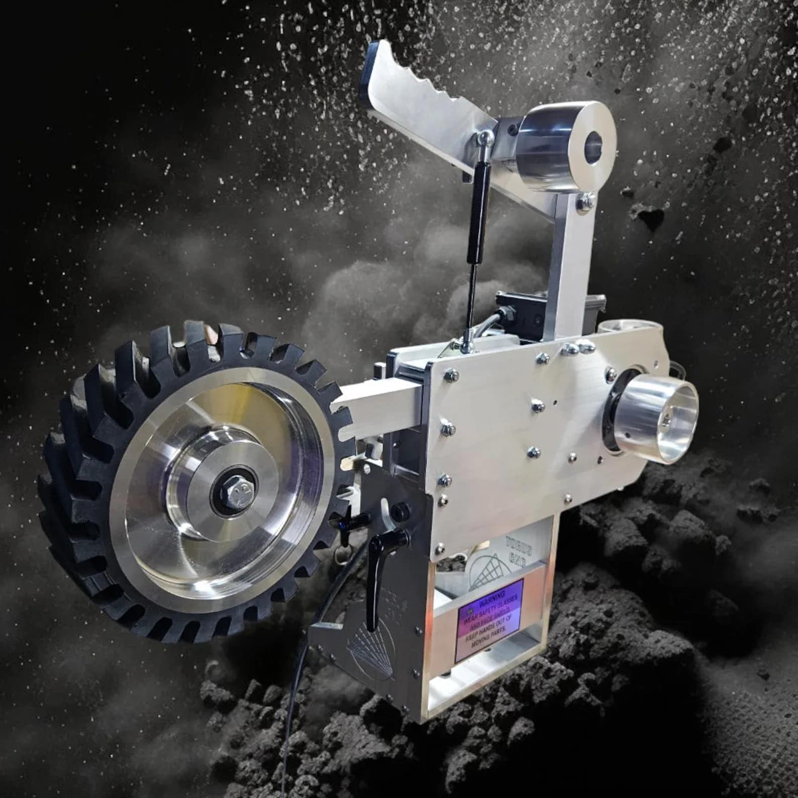 Torus CNC 2x72 belt grinder head with contact wheel against a dust and sparks backdrop