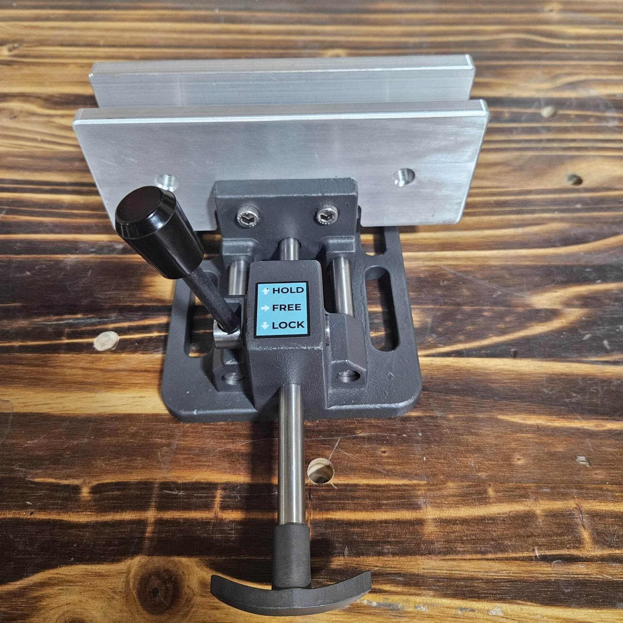 Front view of the Torus CNC quick quench vise with jaws open on a wood workbench