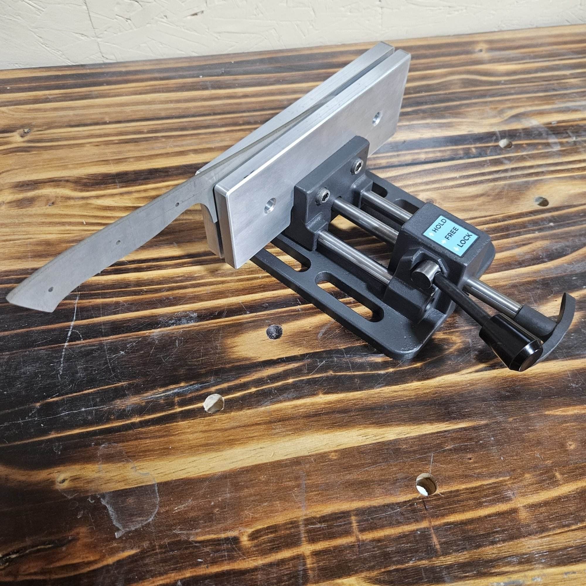 Torus CNC quick quench vise holding a knife blade blank at an angle on a workbench
