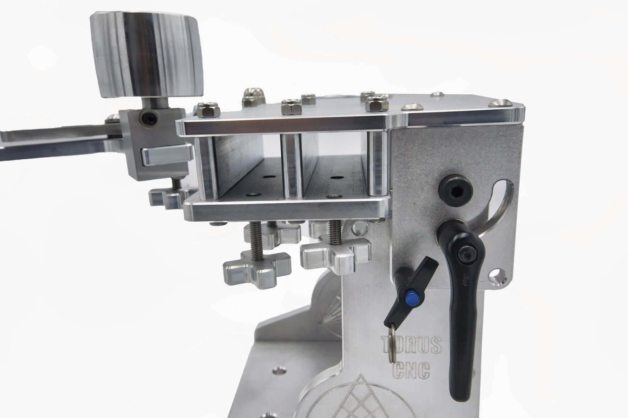 Cross-knob tension adjusters and idler wheel mount on a Torus CNC 2x72 grinder tooling arm