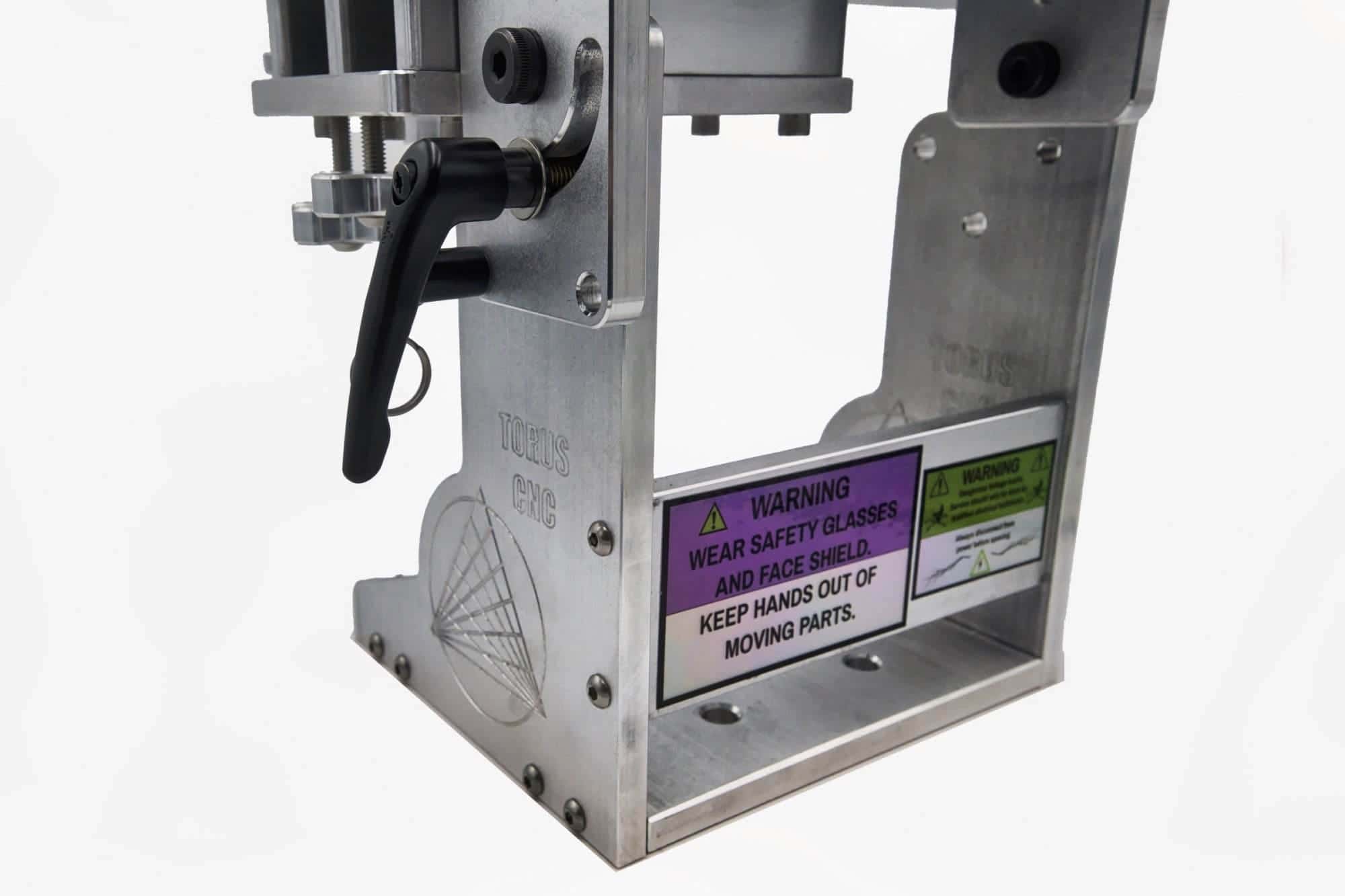 Machined aluminum base of a Torus CNC tooling arm with engraved logo and locking lever detail