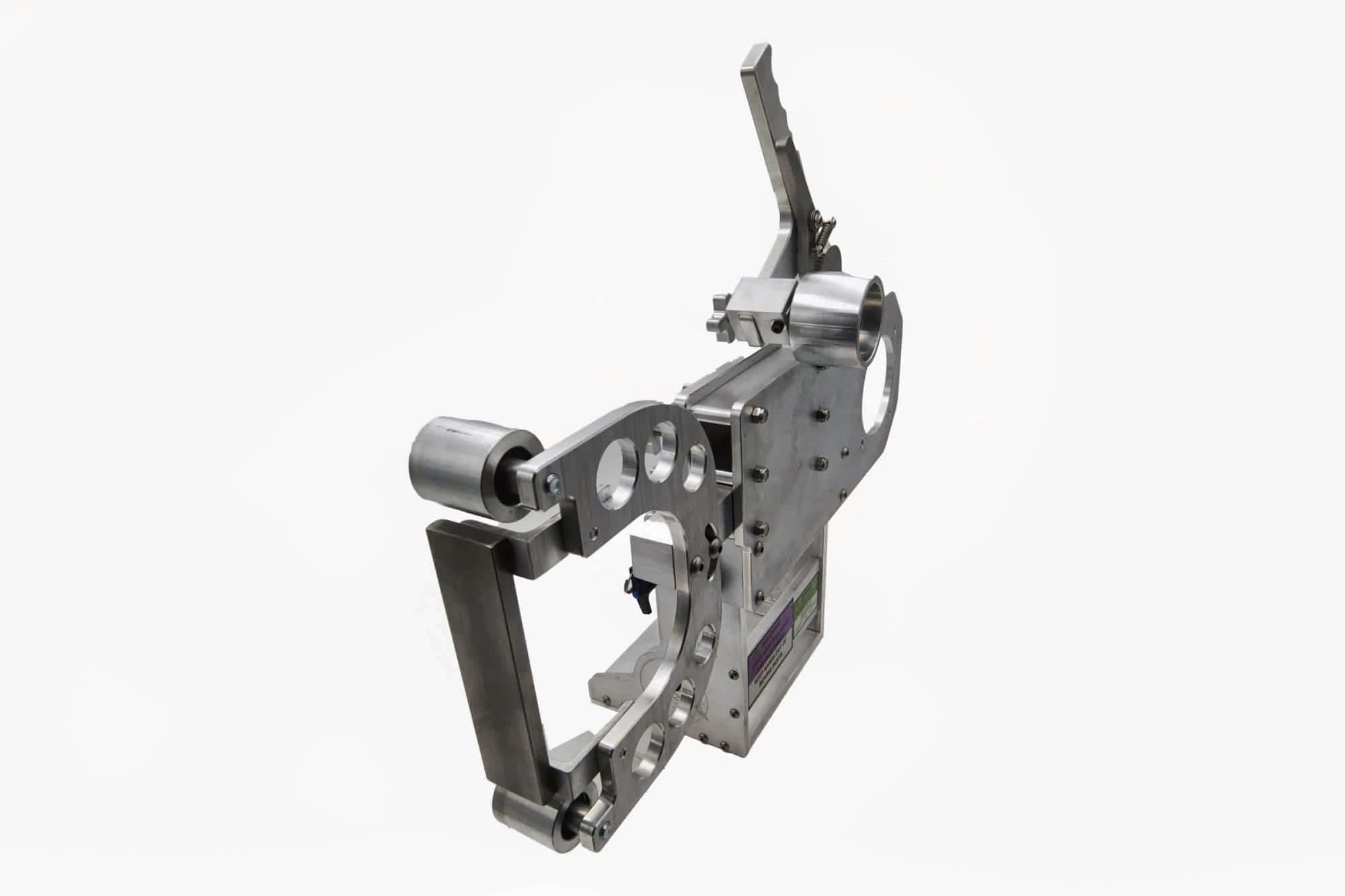 Torus CNC grinder tooling arm with contact wheel and safety warning labels on the base