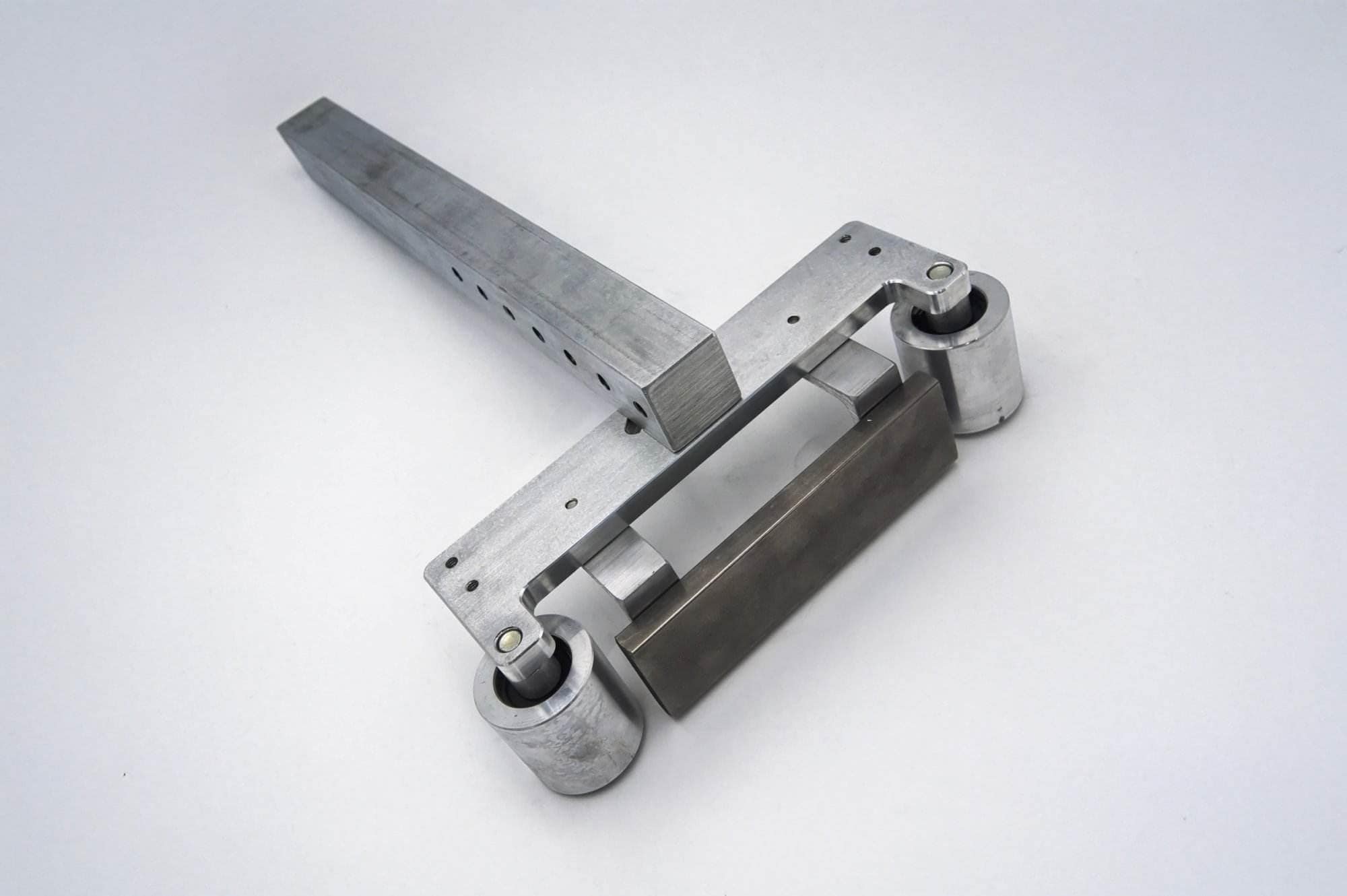 Aluminum pivot linkage arm with dual roller bearings for a 2x72 belt grinder tracking system