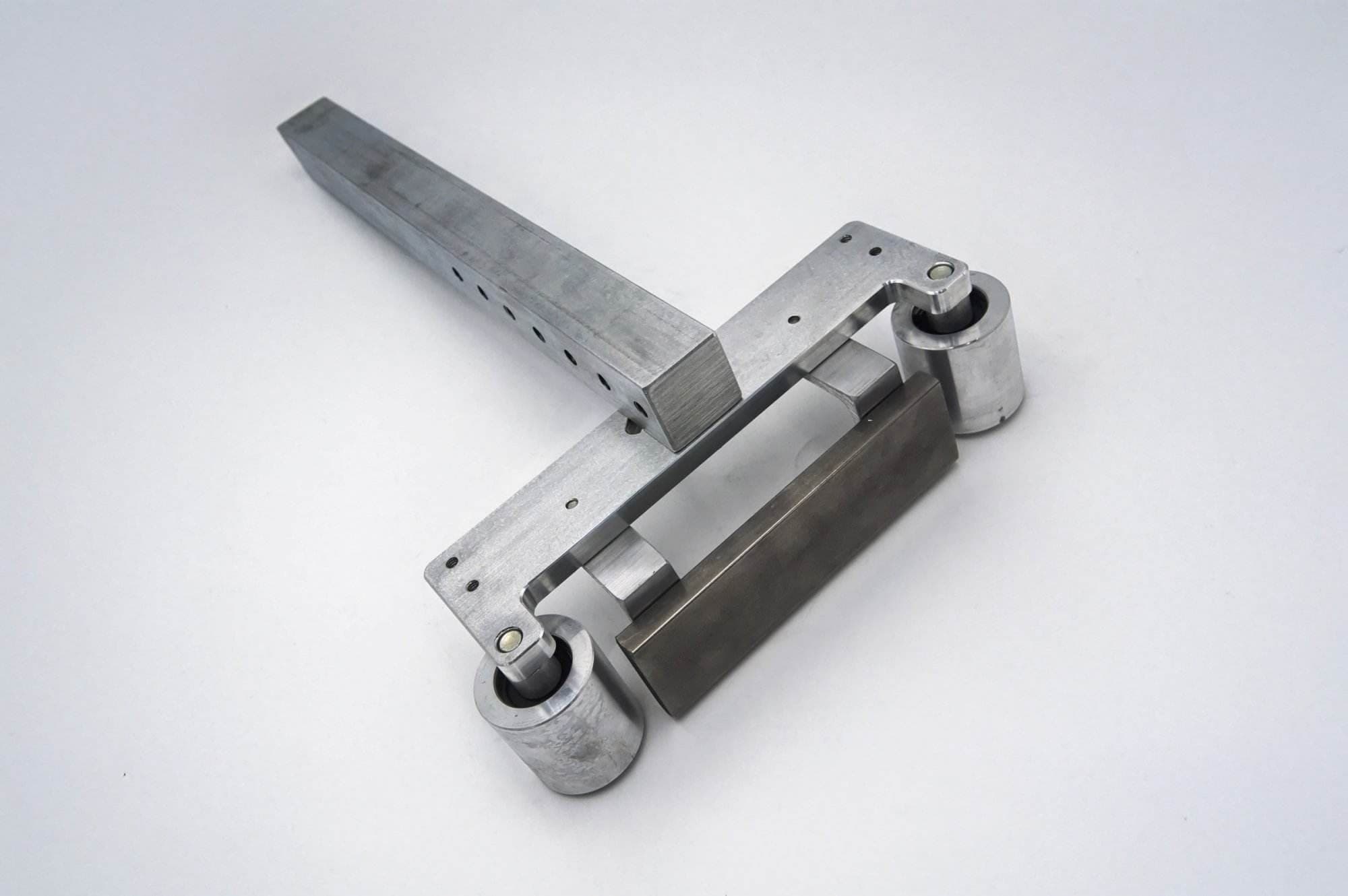 Aluminum pivot linkage arm with dual roller bearings for a 2x72 belt grinder tracking system