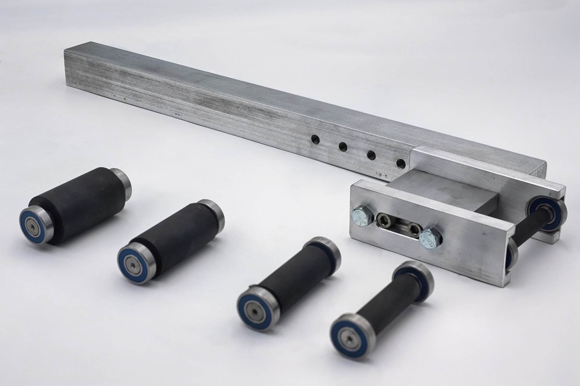 Cogged rubber-toothed drive wheel mounted on an aluminum shaft with a row of adjustment holes