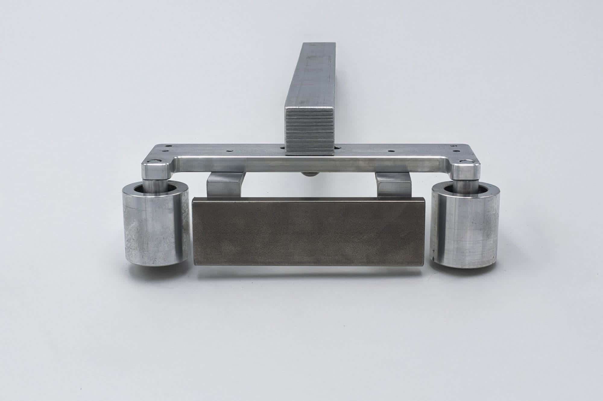 Straight-on view of the Torus CNC quick-detach work rest arm on a white studio background