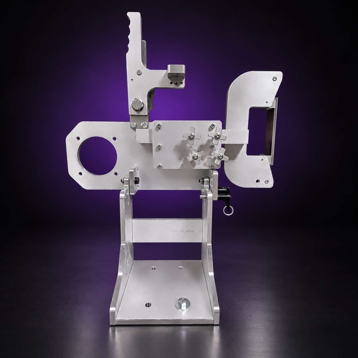 Classic aluminum 2x72 grinder from the rear: four star knobs, motor-mount plate, base bar, on black with a purple glow