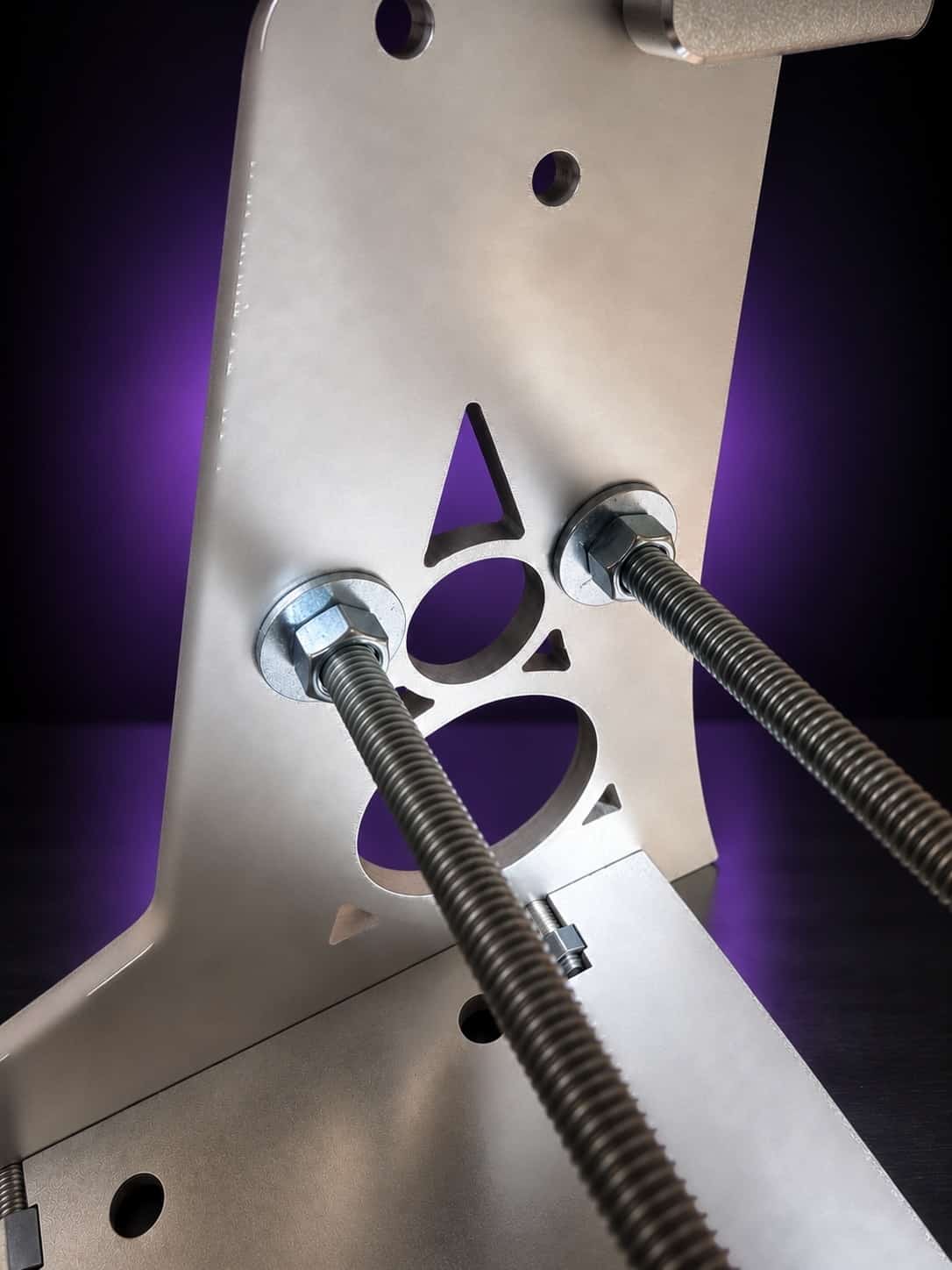 Nova aluminum base upright with two threaded cross-bracing rods, close-up, on black with a purple glow