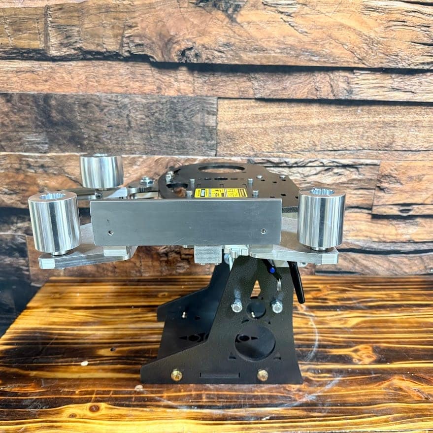 Torus Nebula grinder tilted horizontally, with its flat platen and three aluminum wheels exposed.